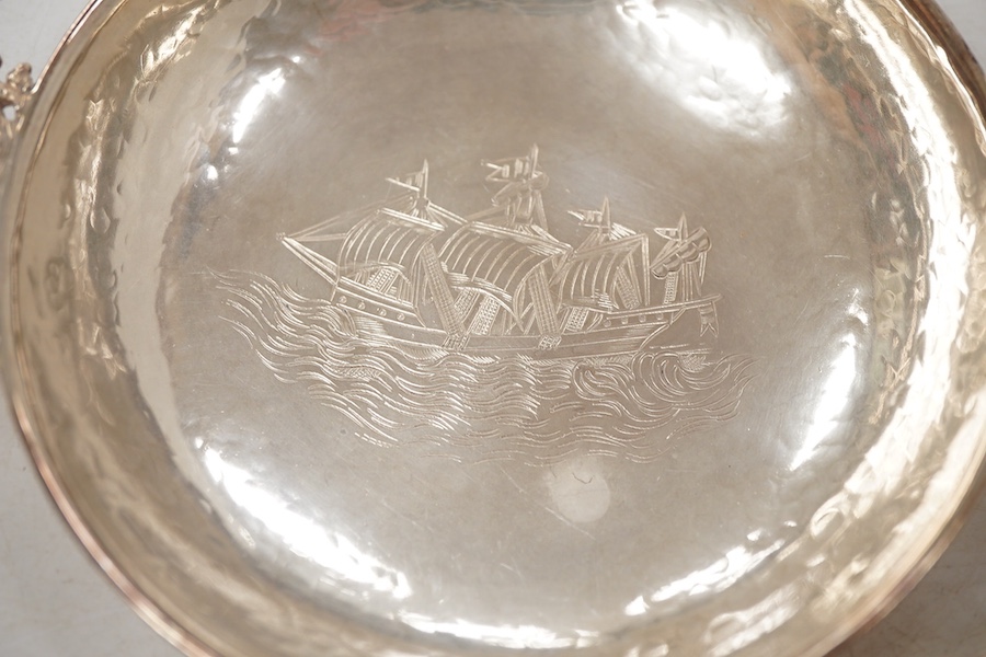 A pair of George V continental silver quaichs, with pierced lug handles and each engraved with a three-masted ship at sea, import marks for Berthold Hermann Muller, London, 1913, 17.3cm.